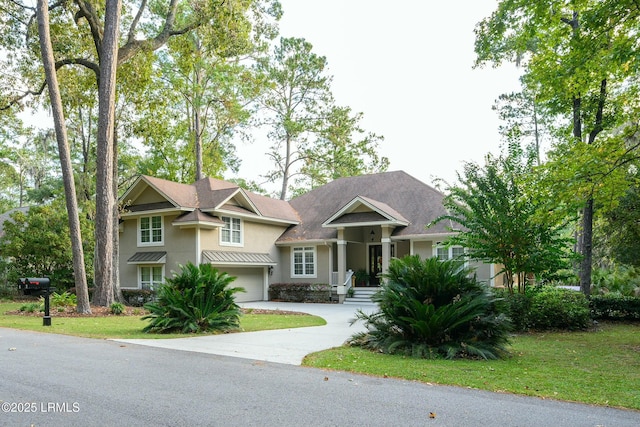 view of front of property with a garage and a front yard