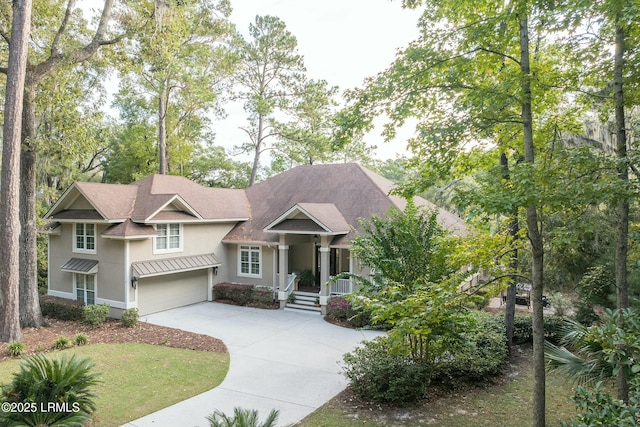 craftsman-style home with concrete driveway, a garage, and stucco siding