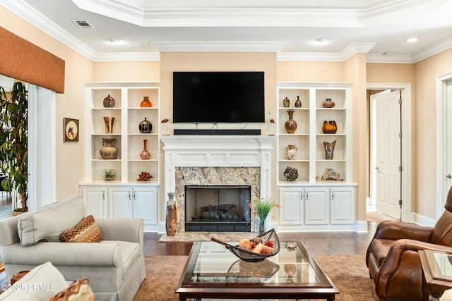 living room with ornamental molding, a fireplace, and light hardwood / wood-style floors