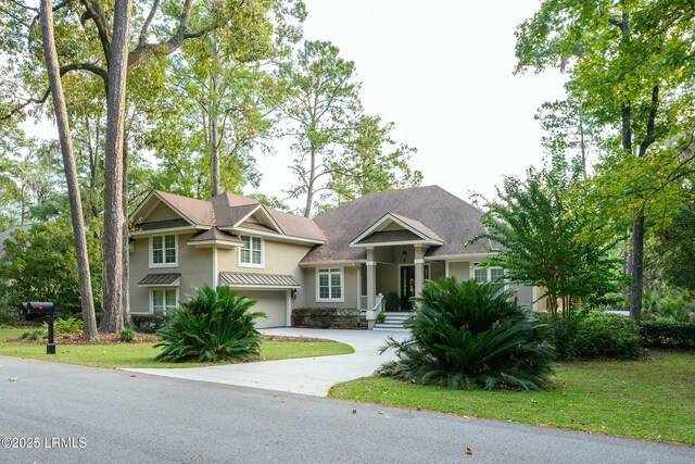 view of front facade with a garage and a front lawn