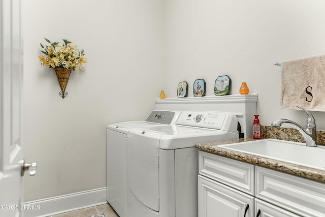 laundry room featuring cabinet space, light tile patterned floors, baseboards, independent washer and dryer, and a sink