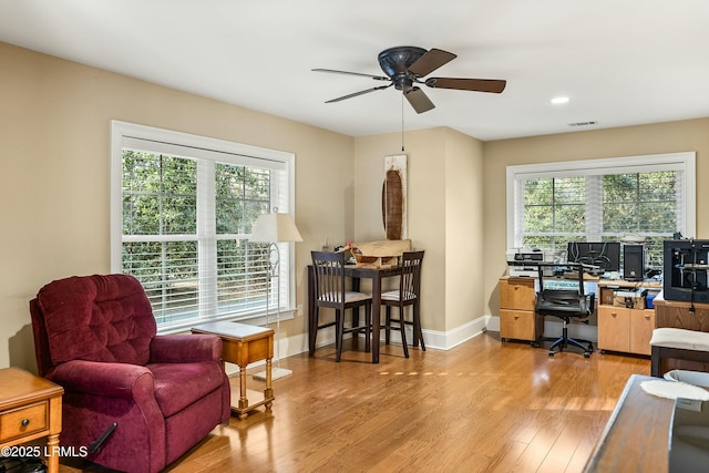 office with ceiling fan, plenty of natural light, and light hardwood / wood-style floors