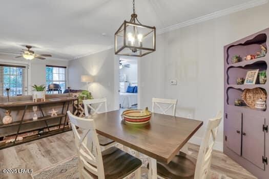 50 Pebble Beach Cv Unit F111, Bluffton, SC 29910 - dining area with a ceiling fan, light wood finished floors, ornamental molding, and a chandelier