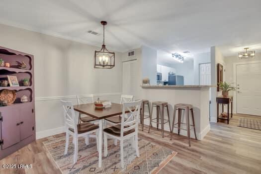 50 Pebble Beach Cv Unit F111, Bluffton, SC 29910 - dining space with a chandelier and light wood finished floors