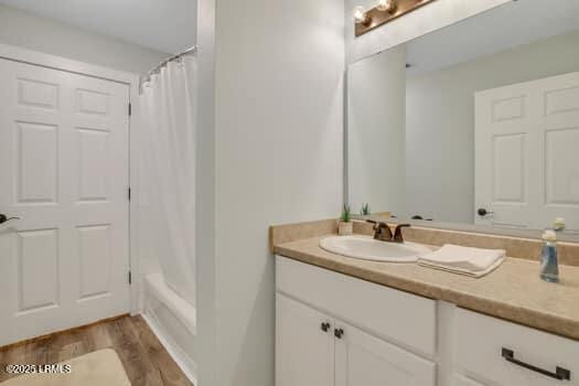 50 Pebble Beach Cv Unit F111, Bluffton, SC 29910 - full bath featuring vanity, wood finished floors, and shower / bath combination with curtain
