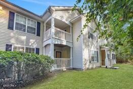 50 Pebble Beach Cv Unit F111, Bluffton, SC 29910 - back of house with a balcony and a lawn