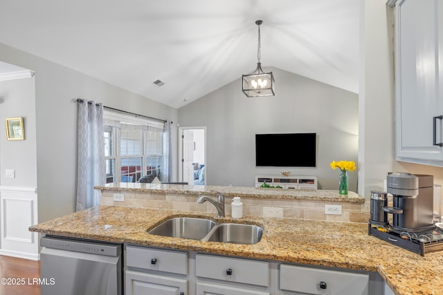 kitchen featuring lofted ceiling, a sink, visible vents, open floor plan, and dishwasher