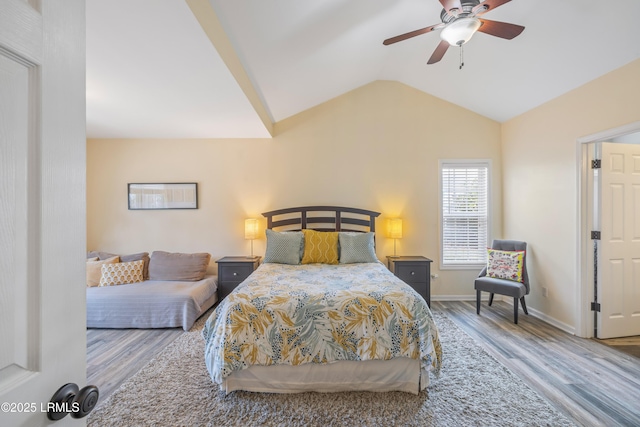 bedroom featuring lofted ceiling, wood finished floors, a ceiling fan, and baseboards