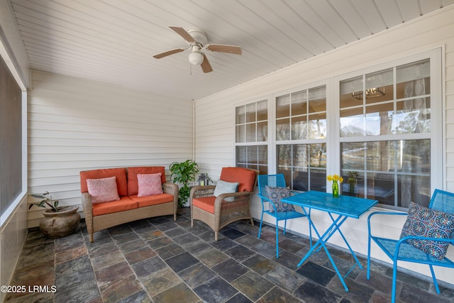 sunroom featuring wood ceiling and ceiling fan