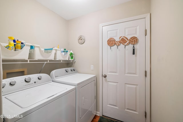 clothes washing area with washing machine and dryer and laundry area