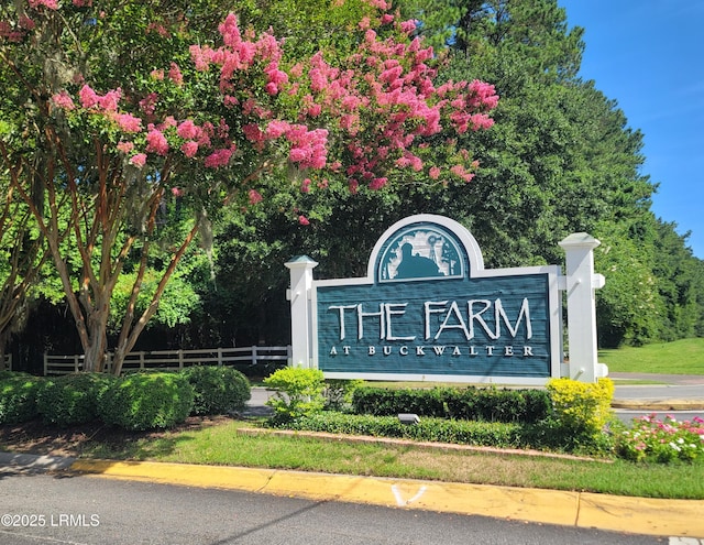 community sign featuring fence