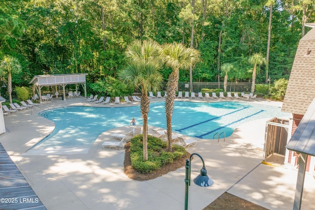 pool with fence and a patio