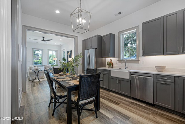 1411 Duke St, Beaufort, SC 29902 - kitchen with stainless steel appliances, gray cabinets, light countertops, wood finished floors, and recessed lighting