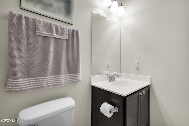 bathroom featuring toilet and vanity