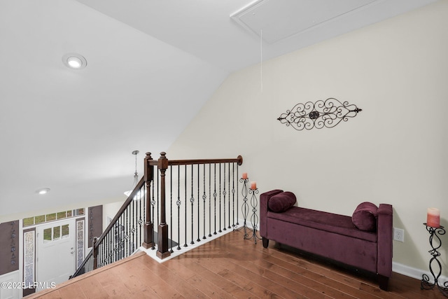 interior space featuring an upstairs landing, baseboards, wood-type flooring, attic access, and recessed lighting