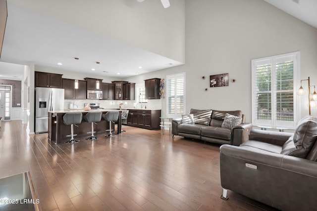 living room with wood finished floors and a healthy amount of sunlight