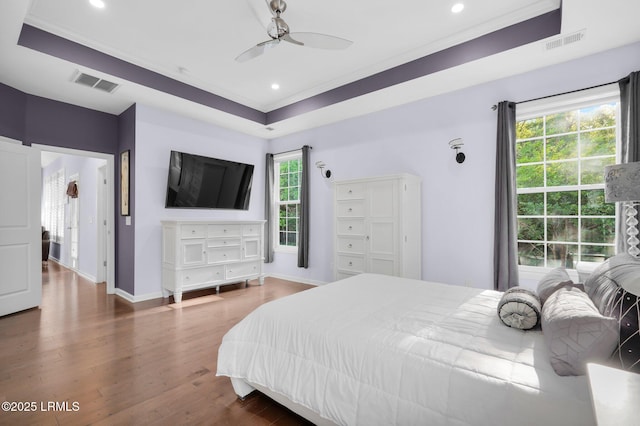 bedroom with recessed lighting, visible vents, wood finished floors, and baseboards