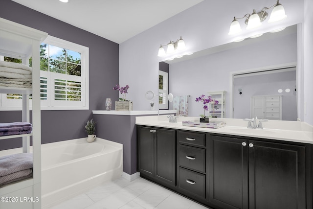 full bathroom with a garden tub, double vanity, and a sink