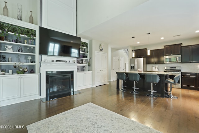 36 Hopper Ridge Rd, Okatie, SC 29909 - kitchen featuring stainless steel appliances, dark wood-style flooring, a kitchen breakfast bar, a center island, and recessed lighting