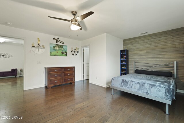 36 Hopper Ridge Rd, Okatie, SC 29909 - bedroom with wood finished floors, baseboards, a ceiling fan, an accent wall, and wood walls