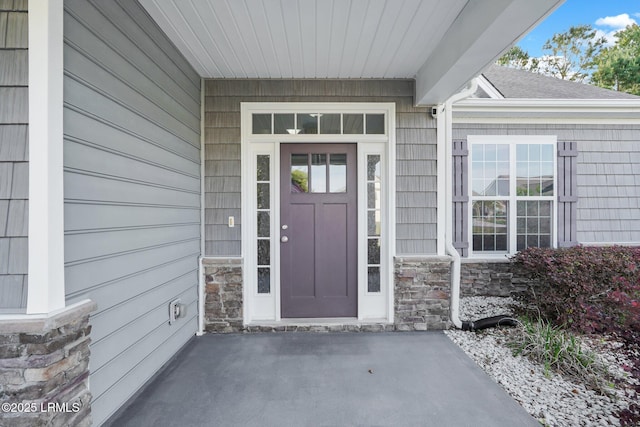 doorway to property with stone siding
