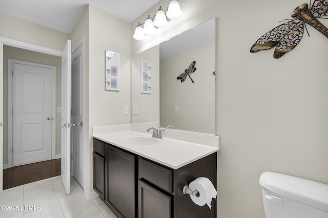 bathroom featuring marble finish floor, toilet, and vanity