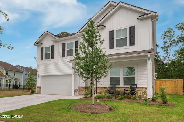craftsman-style house featuring a porch, board and batten siding, an attached garage, and fence