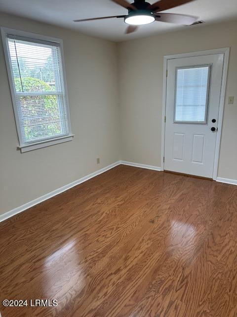 foyer entrance featuring wood-type flooring and ceiling fan