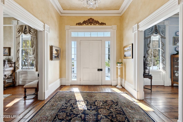 foyer with an inviting chandelier and hardwood / wood-style flooring