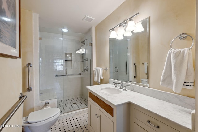 bathroom with vanity, an enclosed shower, and toilet