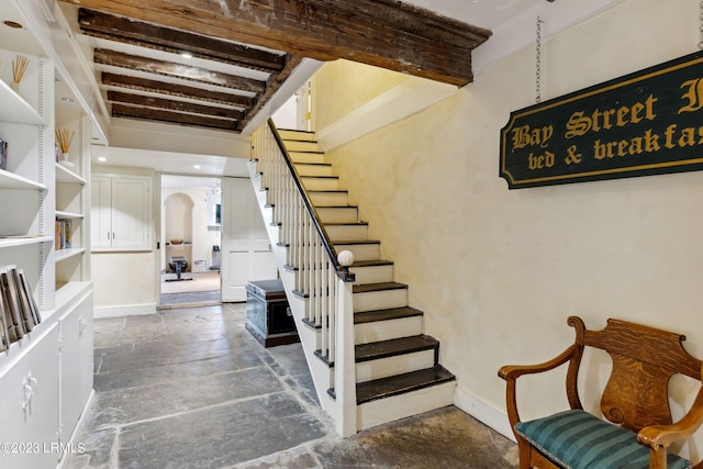 staircase with beam ceiling