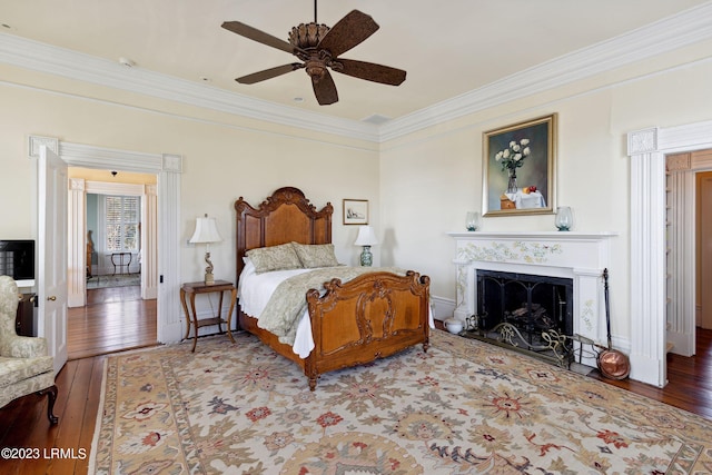 bedroom with ceiling fan, wood-type flooring, and ornamental molding