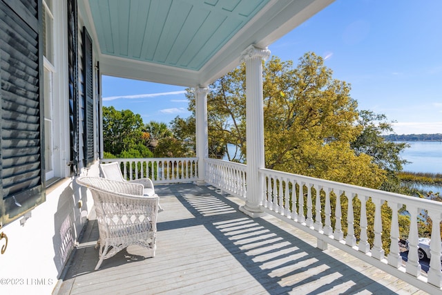 wooden terrace with a water view