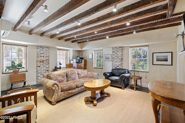 living room with a wall mounted AC and beam ceiling