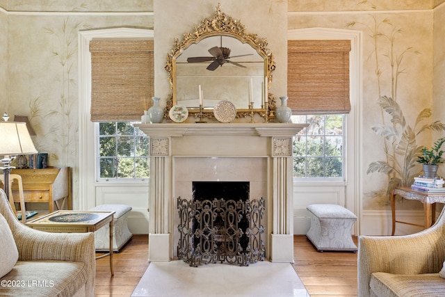 sitting room with hardwood / wood-style floors, a fireplace, and ceiling fan