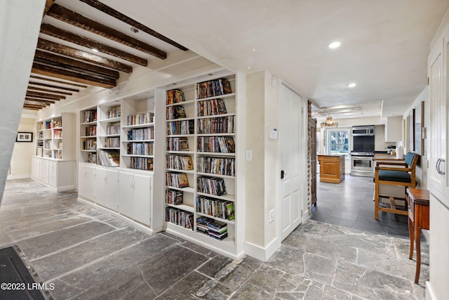 corridor featuring beam ceiling and built in features