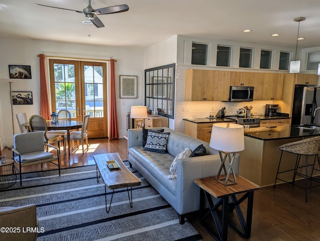 living room with sink, french doors, dark hardwood / wood-style floors, and ceiling fan