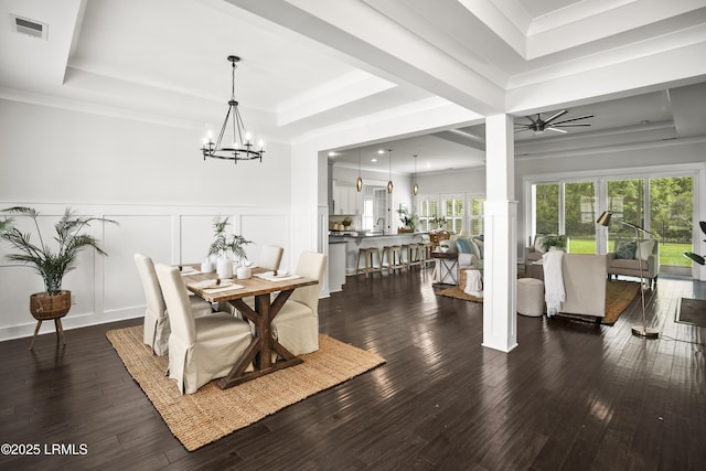 135 Danbridge Ct, Bluffton, SC 29910 - dining room with a tray ceiling, a decorative wall, a chandelier, dark wood-style flooring, and wainscoting