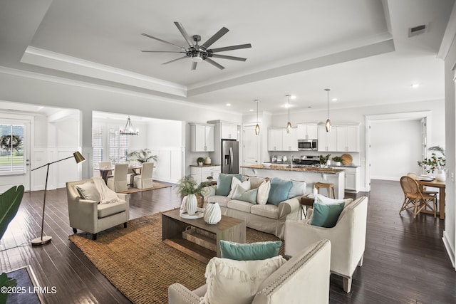 135 Danbridge Ct, Bluffton, SC 29910 - living area with a tray ceiling, a ceiling fan, a chandelier, ornamental molding, and recessed lighting