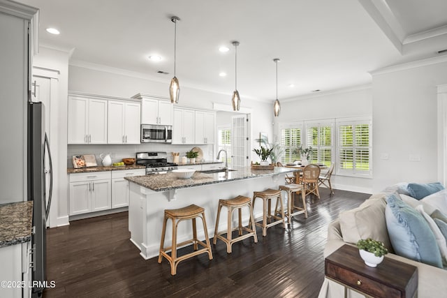 135 Danbridge Ct, Bluffton, SC 29910 - kitchen with appliances with stainless steel finishes, decorative backsplash, open floor plan, a breakfast bar, and dark stone countertops
