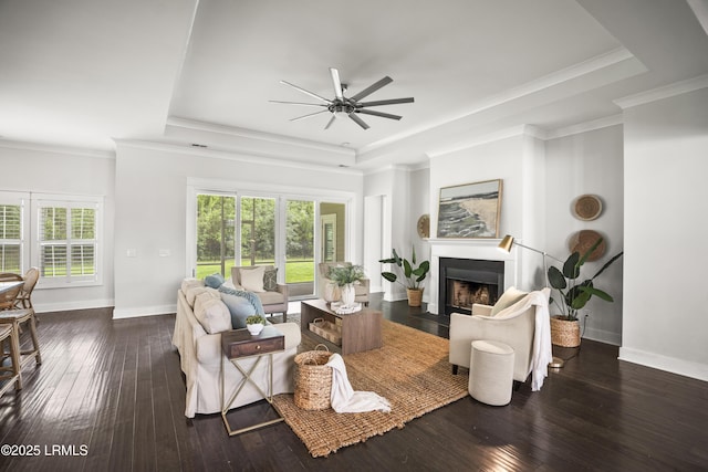 135 Danbridge Ct, Bluffton, SC 29910 - living room with a raised ceiling, a ceiling fan, a fireplace with flush hearth, dark wood-style floors, and crown molding