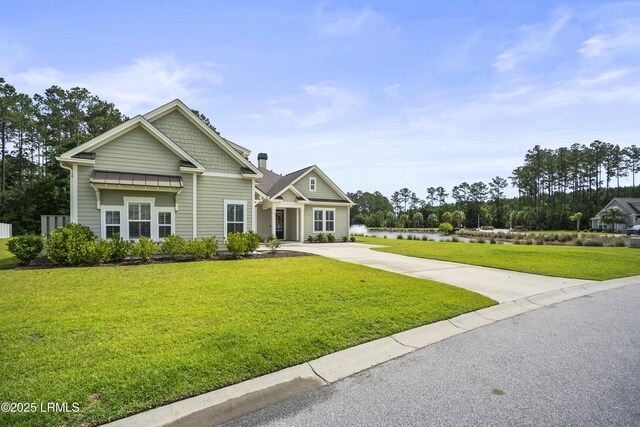135 Danbridge Ct, Bluffton, SC 29910 - craftsman house featuring driveway, a front lawn, and a water view