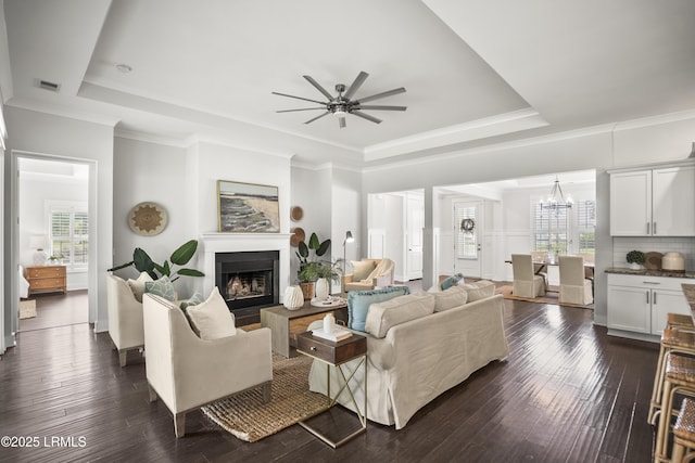 135 Danbridge Ct, Bluffton, SC 29910 - living room with a raised ceiling, ceiling fan, healthy amount of natural light, a fireplace, and ornamental molding