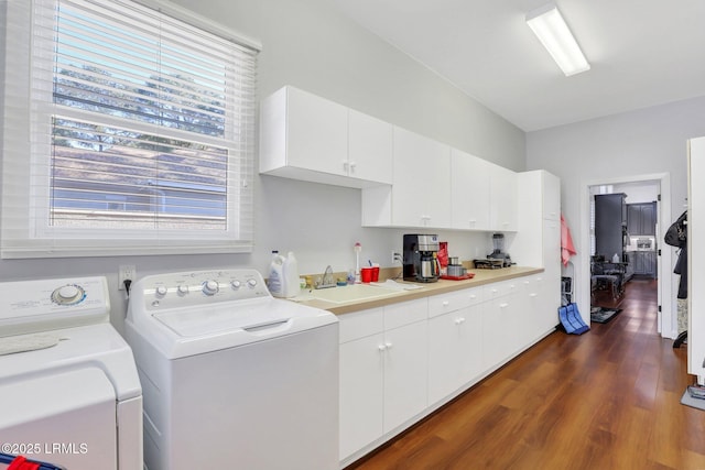 laundry area with cabinets, separate washer and dryer, sink, and dark hardwood / wood-style flooring