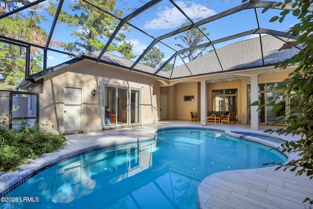 view of swimming pool featuring a lanai and a patio area