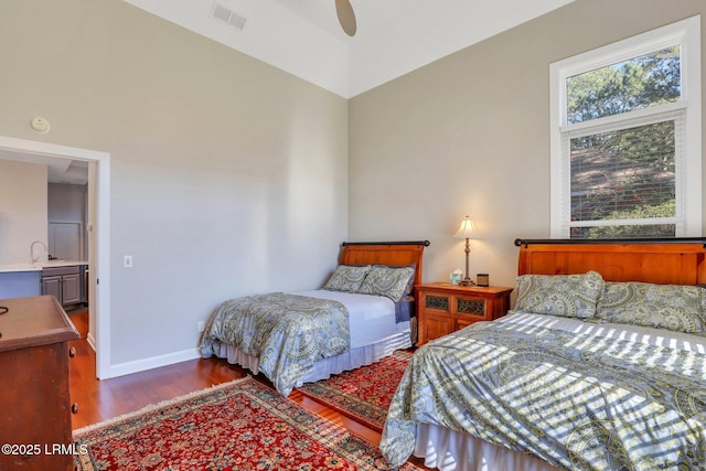 bedroom with hardwood / wood-style flooring, sink, and ceiling fan