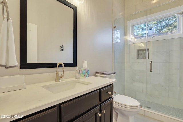 bathroom featuring vanity, toilet, and walk in shower