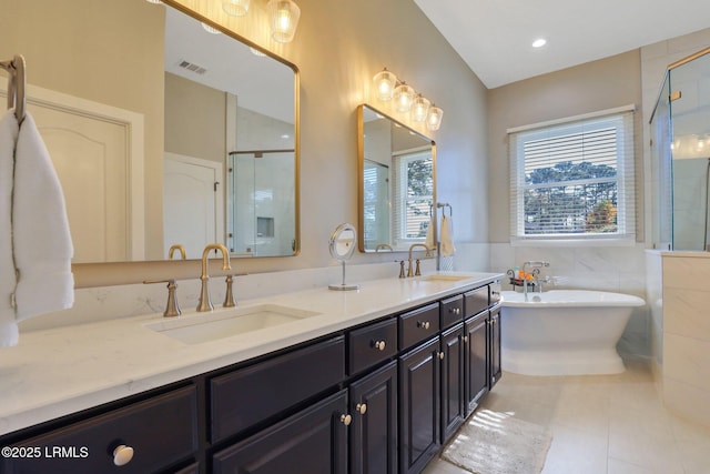 bathroom featuring vanity, tile patterned floors, tile walls, and separate shower and tub