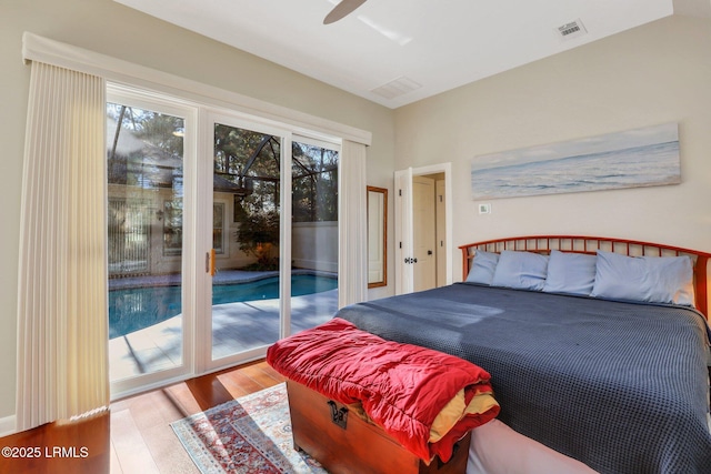 bedroom featuring multiple windows, access to exterior, light hardwood / wood-style floors, and ceiling fan