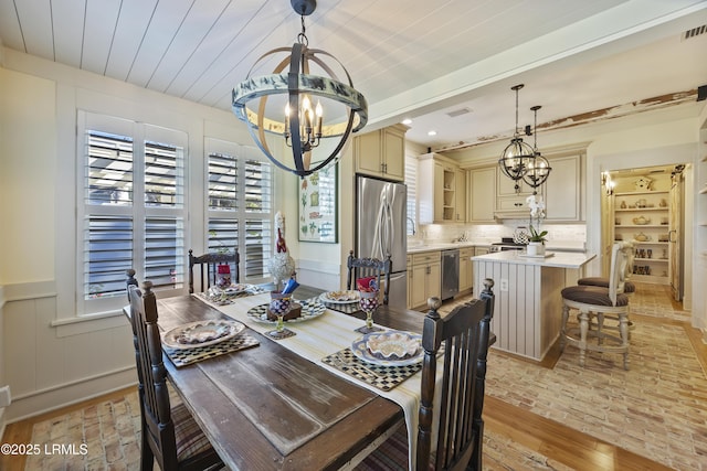 625 Spanish Wells Rd Unit 12, Hilton Head Island, SC 29926 - dining space featuring an inviting chandelier, brick floor, and visible vents
